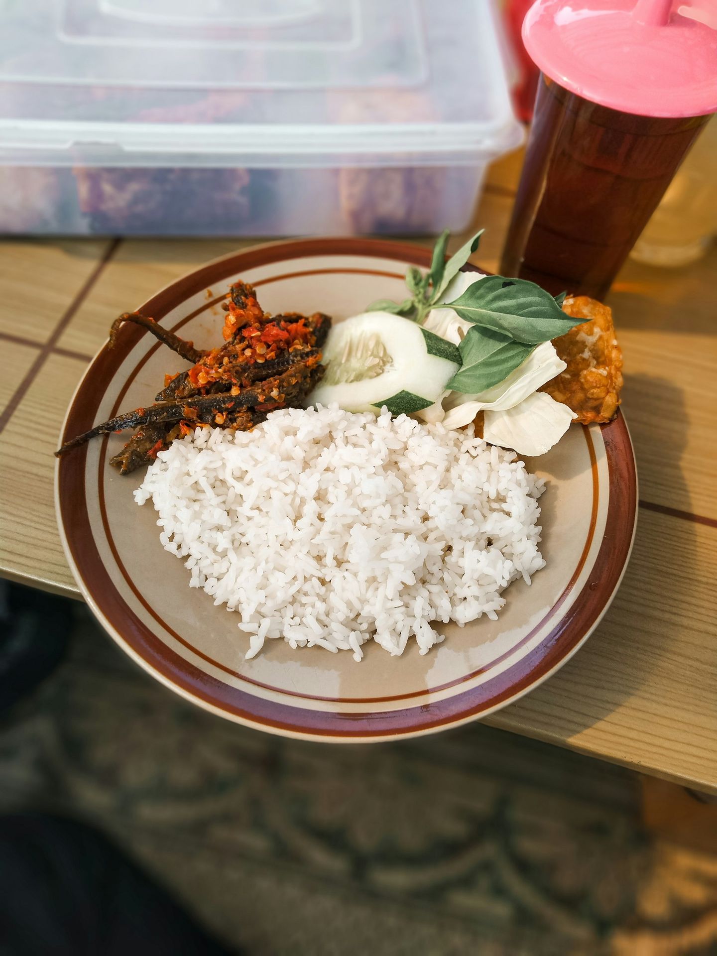 a plate of rice, meat and vegetables on a table